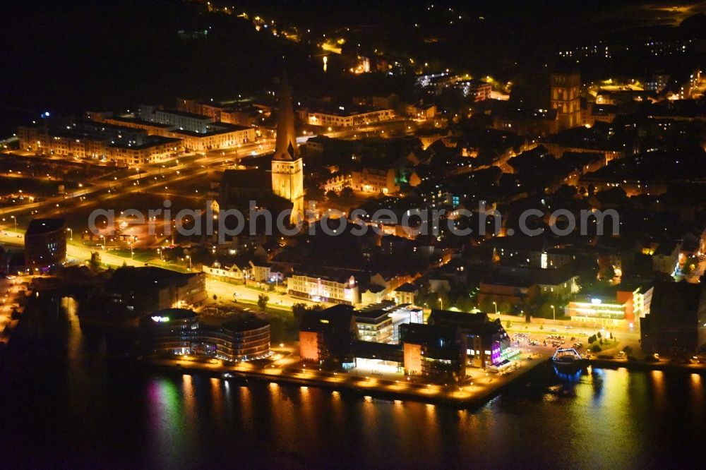 Aerial image at night Rostock - Night lighting Village on the banks of the area Unterwarnow - river course in Rostock in the state Mecklenburg - Western Pomerania, Germany