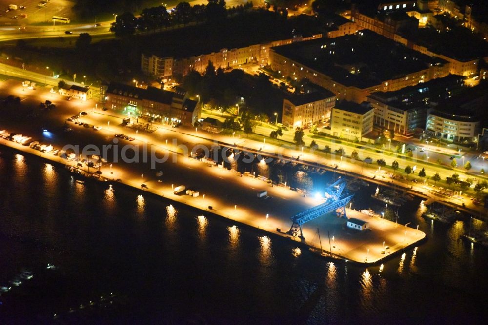 Aerial image at night Rostock - Night lighting Village on the banks of the area Unterwarnow - river course in Rostock in the state Mecklenburg - Western Pomerania, Germany