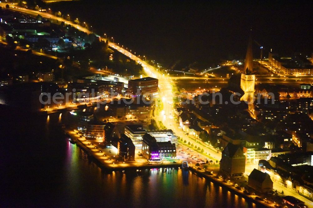 Rostock at night from above - Night lighting Village on the banks of the area Unterwarnow - river course in Rostock in the state Mecklenburg - Western Pomerania, Germany