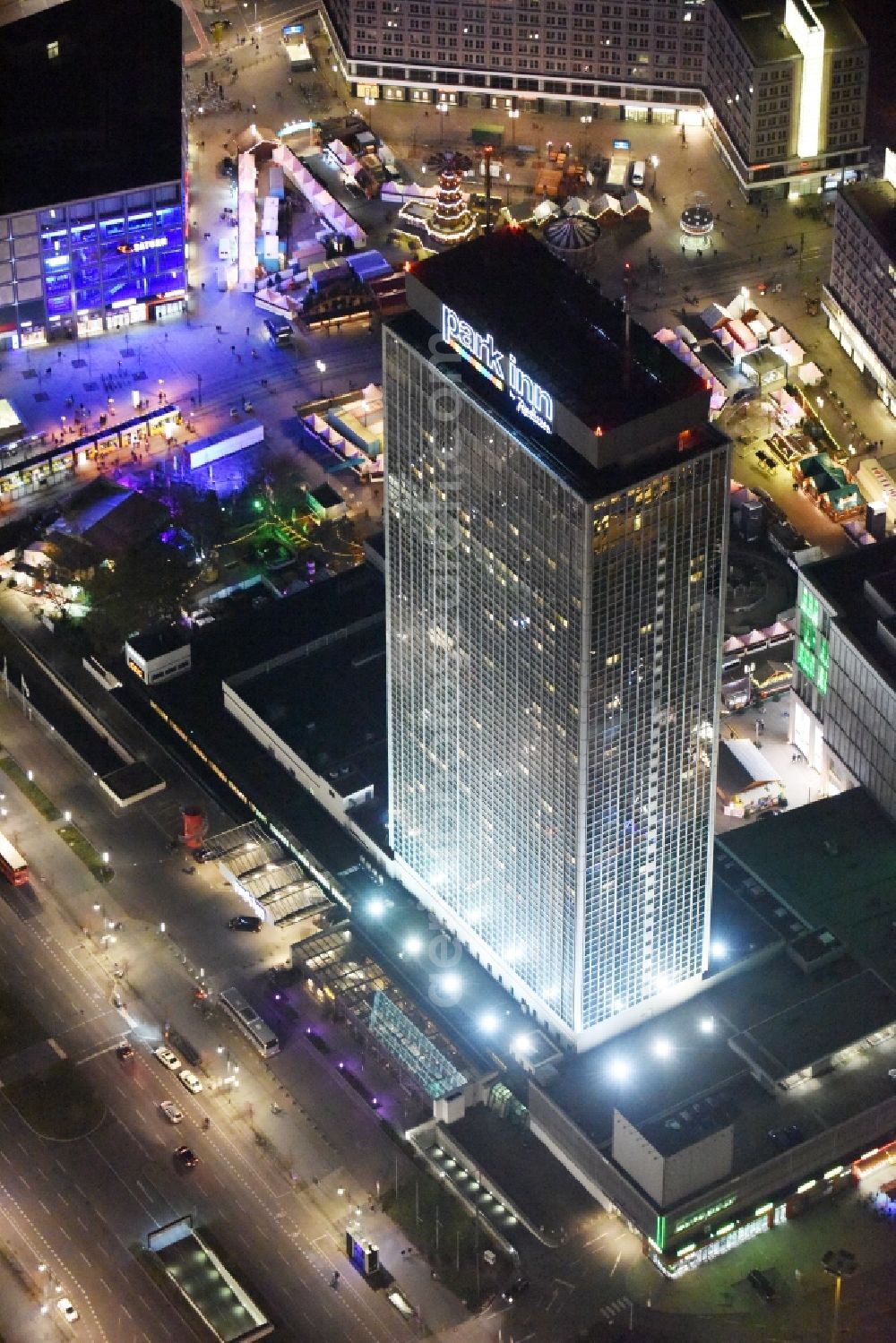 Aerial image at night Berlin - Night view overlooking illuminated building of the Park Inn Hotel at the Alexanderplatz in the city center of Berlin