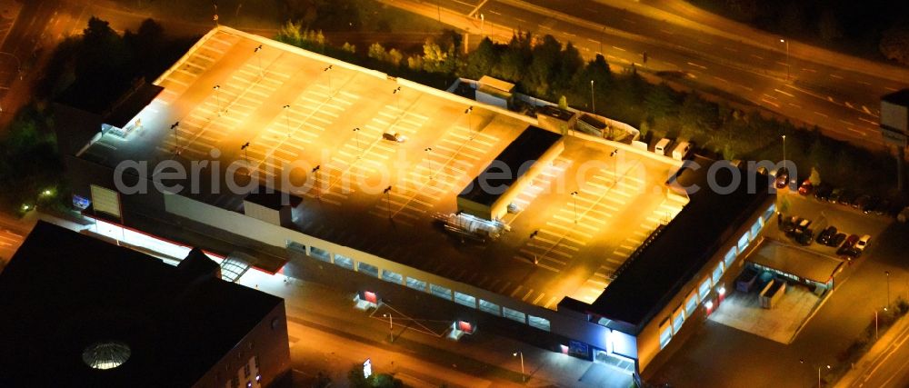 Neubrandenburg at night from above - Night lighting Parking deck on the building of the car park Lindetal Center on Juri-Gagarin-Ring in Neubrandenburg in the state Mecklenburg - Western Pomerania, Germany