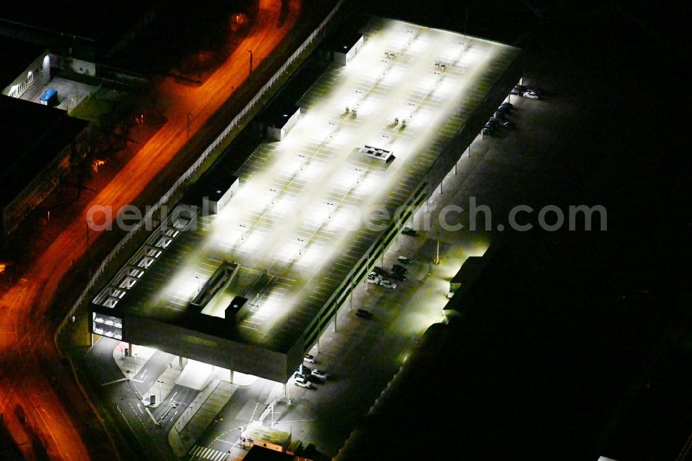 München at night from above - Night lighting parking deck on the building of the car park on Alois-Wolfmueller-Strasse in the district Schwabing-Freimann in Munich in the state Bavaria, Germany