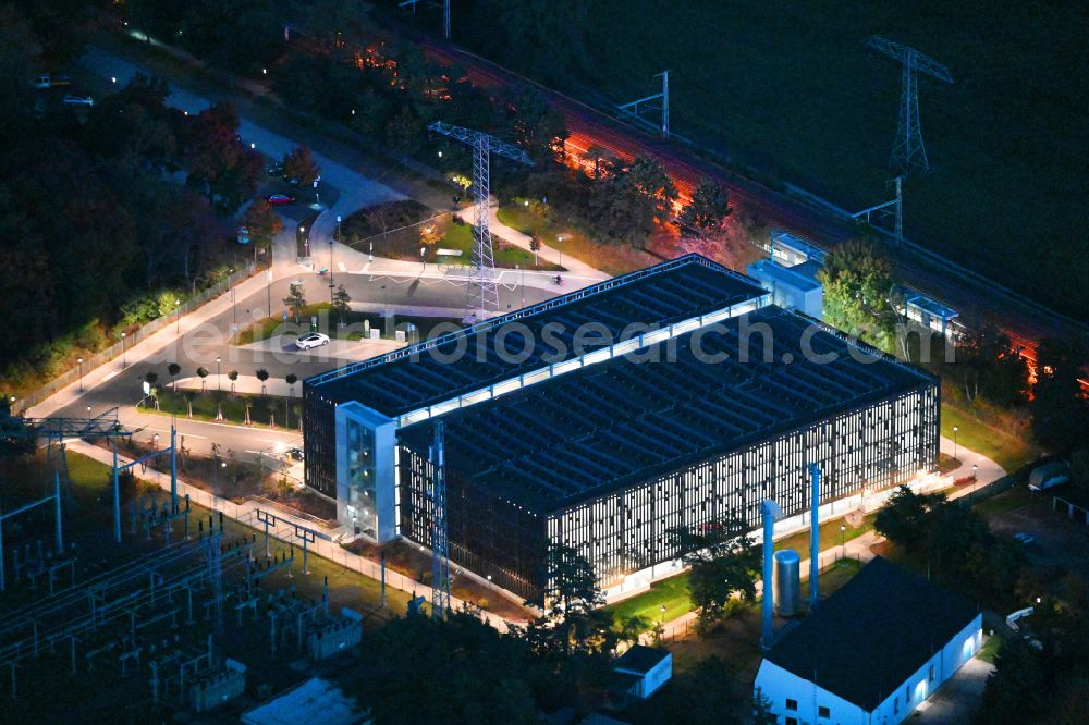 Aerial photograph at night Bernau - Night lighting parking garage bevore train station on Lenastrasse on street Angarastrasse in the district Friedenstal in Bernau in the state Brandenburg, Germany