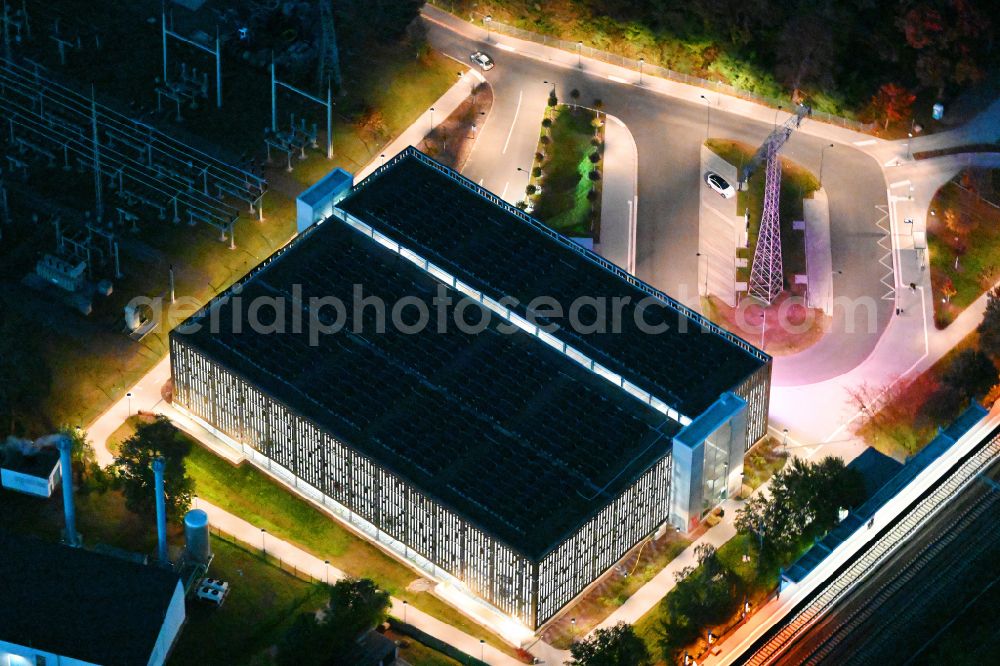 Aerial image at night Bernau - Night lighting parking garage bevore train station on Lenastrasse on street Angarastrasse in the district Friedenstal in Bernau in the state Brandenburg, Germany