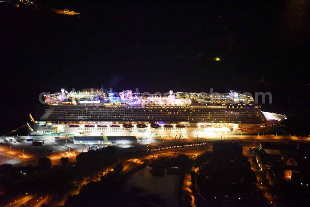 Aerial image at night Rostock - Night lighting Passenger ship Norwegian Getaway in the district Warnemuende in Rostock in the state Mecklenburg - Western Pomerania, Germany