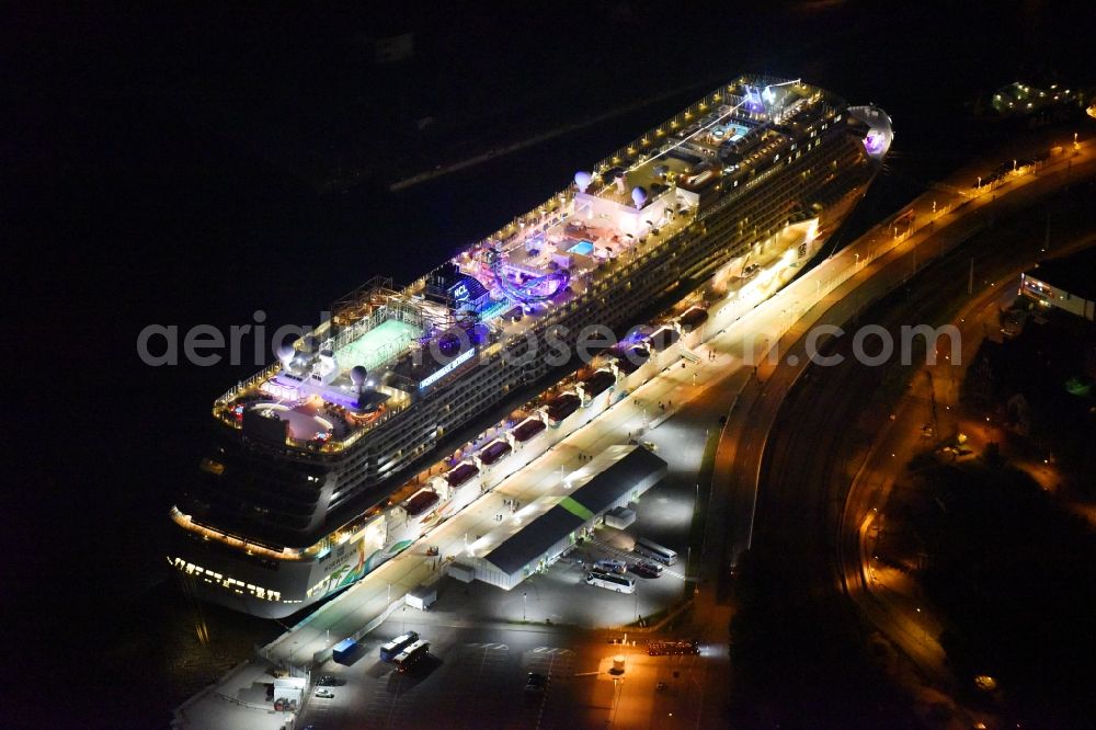 Rostock at night from the bird perspective: Night lighting Passenger ship Norwegian Getaway in the district Warnemuende in Rostock in the state Mecklenburg - Western Pomerania, Germany