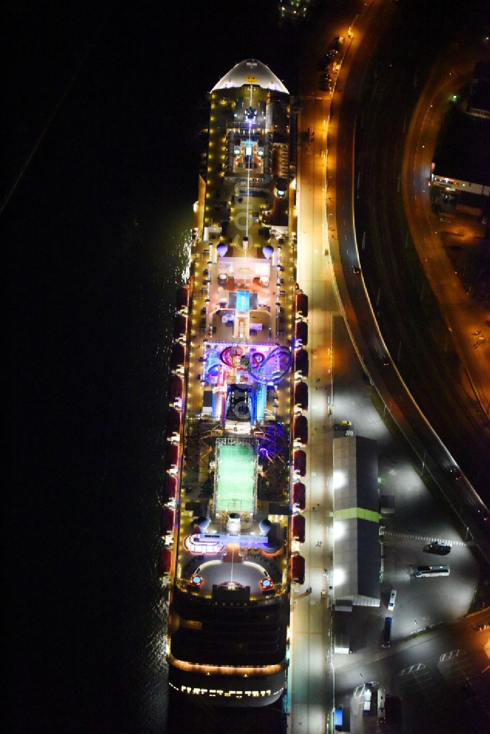 Rostock at night from the bird perspective: Night lighting Passenger ship Norwegian Getaway in the district Warnemuende in Rostock in the state Mecklenburg - Western Pomerania, Germany