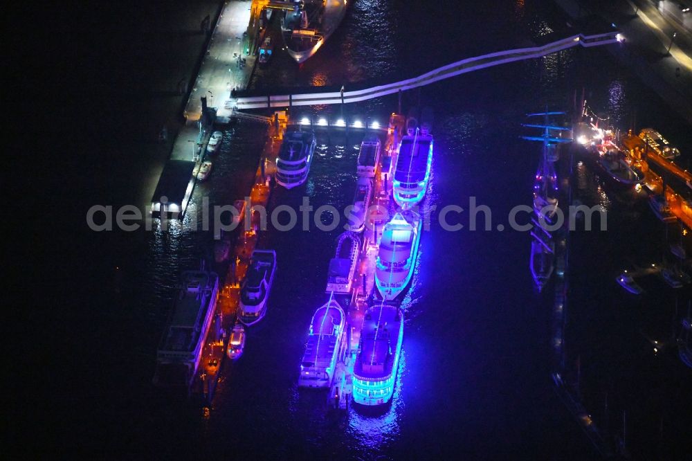 Aerial image at night Hamburg - Night lighting passenger ships in Hafen on Ueberseebruecke in Hamburg, Germany