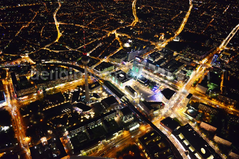 Aerial image at night Berlin - Night lights and lighting square ensemble at Alexanderplatz station - Berlin TV tower in the city center in the Mitte district in Berlin, Germany