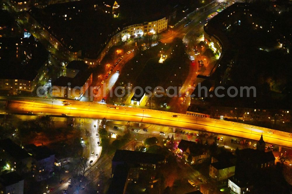 Berlin at night from the bird perspective: Night lighting Ensemble space Breitenbachplatz on Schorlemerallee in the inner city center in the district Dahlem in Berlin, Germany