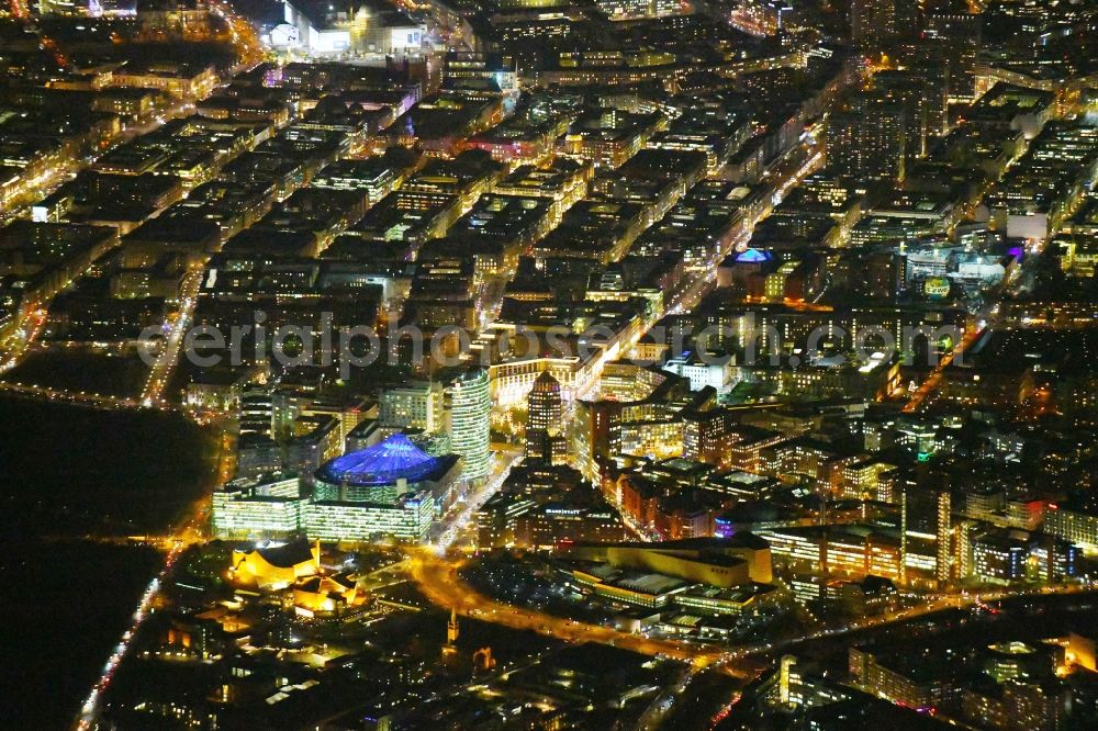 Aerial photograph at night Berlin - Night lighting Ensemble space Potsdamer Platz and Leipziger Platz in the inner city center in Berlin in Germany