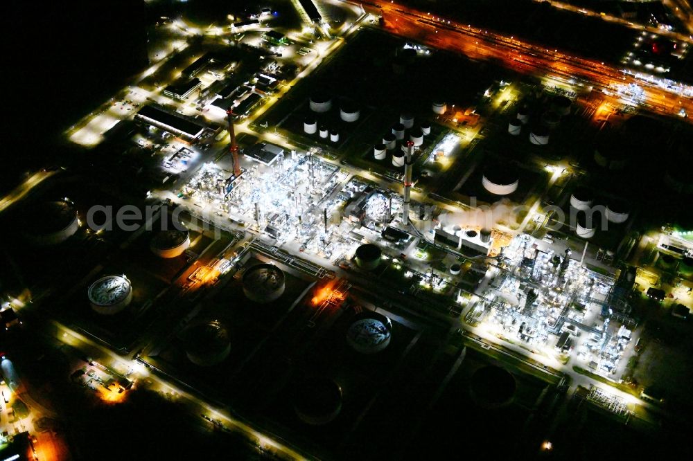 Aerial photograph at night Desching - Night lighting refinery equipment and management systems on the factory premises of the mineral oil manufacturers Gunvor in Desching in the state Bavaria, Germany