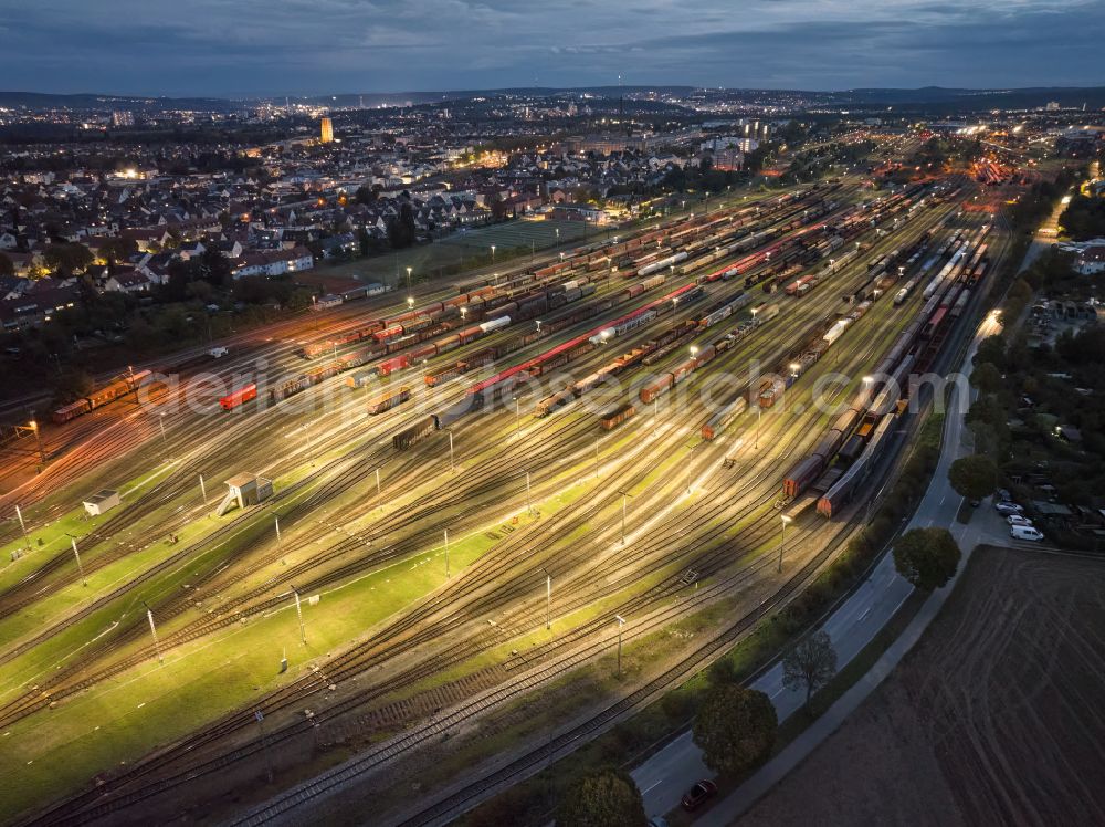 Kornwestheim at night from above - Night lighting marshalling yard and freight station Deutsche Bahn on street Westrandstrasse in Kornwestheim in the state Baden-Wuerttemberg, Germany