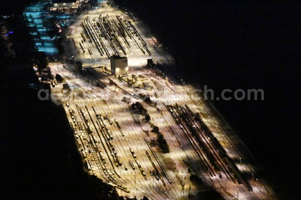 Aerial image at night Neuseddin - Night lighting marshalling yard and freight station of the Deutsche Bahn in Neuseddin in the state Brandenburg