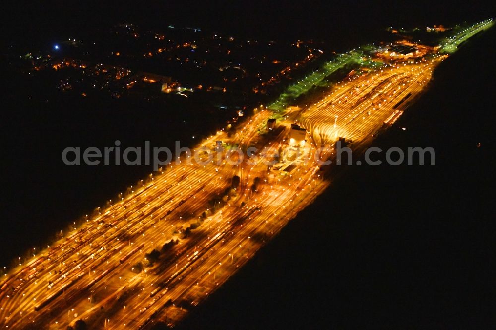 Aerial image at night Neuseddin - Night lighting marshalling yard and freight station of the Deutsche Bahn in Neuseddin in the state Brandenburg