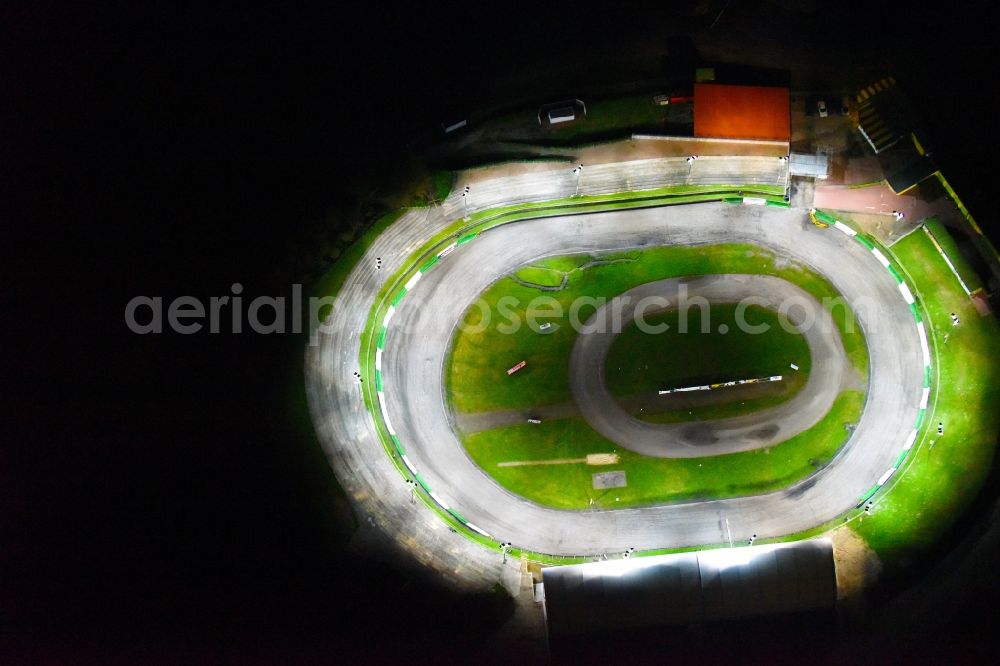 Aerial photograph at night Güstrow - Night lighting Racetrack racecourse of MC Guestrow on Plauer Chaussee in the district Gleviner Burg in Guestrow in the state Mecklenburg - Western Pomerania, Germany