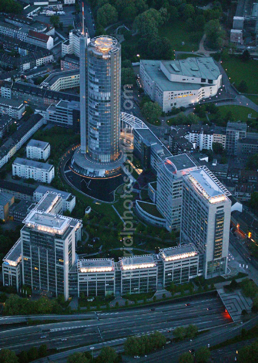 Aerial image at night Essen - Blick auf die RWE-Konzernzentrale in Essen bei Nacht. Der RWE-Turm bildet mit 120 m Höhe und 500 Arbeitsplätzen die Zentrale des Energieversorgers RWE. Das Hochhaus ist ökologische orientiert konzipiert und gewinnt natürliche Energie aus Tageslicht und Sonnenwärme. View of the RWE headquarters in Essen at night. The RWE Tower is with 120 meters and up to 500 workplaces the headquarter of the energy supplier RWE. The tower is designed ecological and gains energy from natural daylight and solar heat.