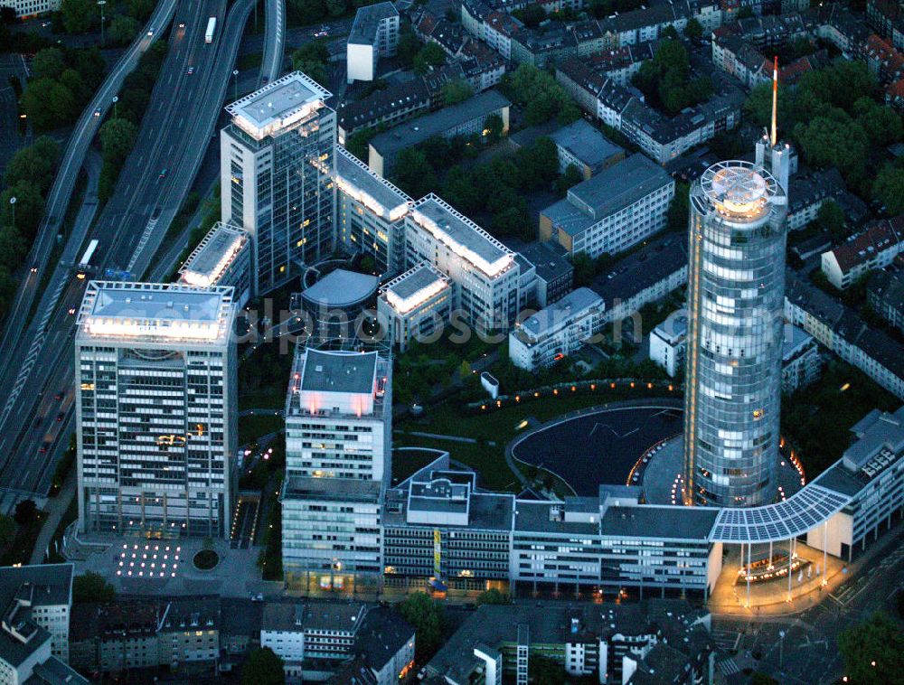 Essen at night from above - Blick auf die RWE-Konzernzentrale in Essen bei Nacht. Der RWE-Turm bildet mit 120 m Höhe und 500 Arbeitsplätzen die Zentrale des Energieversorgers RWE. Das Hochhaus ist ökologische orientiert konzipiert und gewinnt natürliche Energie aus Tageslicht und Sonnenwärme. View of the RWE headquarters in Essen at night. The RWE Tower is with 120 meters and up to 500 workplaces the headquarter of the energy supplier RWE. The tower is designed ecological and gains energy from natural daylight and solar heat.