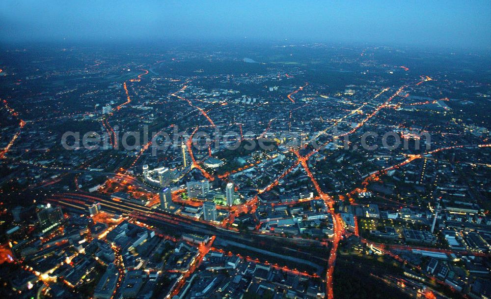 Essen at night from above - Blick auf die RWE-Konzernzentrale in Essen bei Nacht. Der RWE-Turm bildet mit 120 m Höhe und 500 Arbeitsplätzen die Zentrale des Energieversorgers RWE. Das Hochhaus ist ökologische orientiert konzipiert und gewinnt natürliche Energie aus Tageslicht und Sonnenwärme. View of the RWE headquarters in Essen at night. The RWE Tower is with 120 meters and up to 500 workplaces the headquarter of the energy supplier RWE. The tower is designed ecological and gains energy from natural daylight and solar heat.