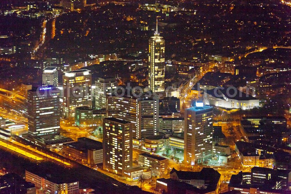 Aerial photograph at night Essen - Nachtluftbild auf die RWE-Konzernzentrale in Essen. Der RWE-Turm bildet mit 120 m Höhe und 500 Arbeitsplätzen die Zentrale des Energieversorgers RWE. Das Hochhaus ist ökologische orientiert konzipiert und gewinnt natürliche Energie aus Tageslicht und Sonnenwärme. View of the RWE headquarters in Essen at night. The RWE Tower is with 120 meters and up to 500 workplaces the headquarter of the energy supplier RWE. The tower is designed ecological and gains energy from natural daylight and solar heat.