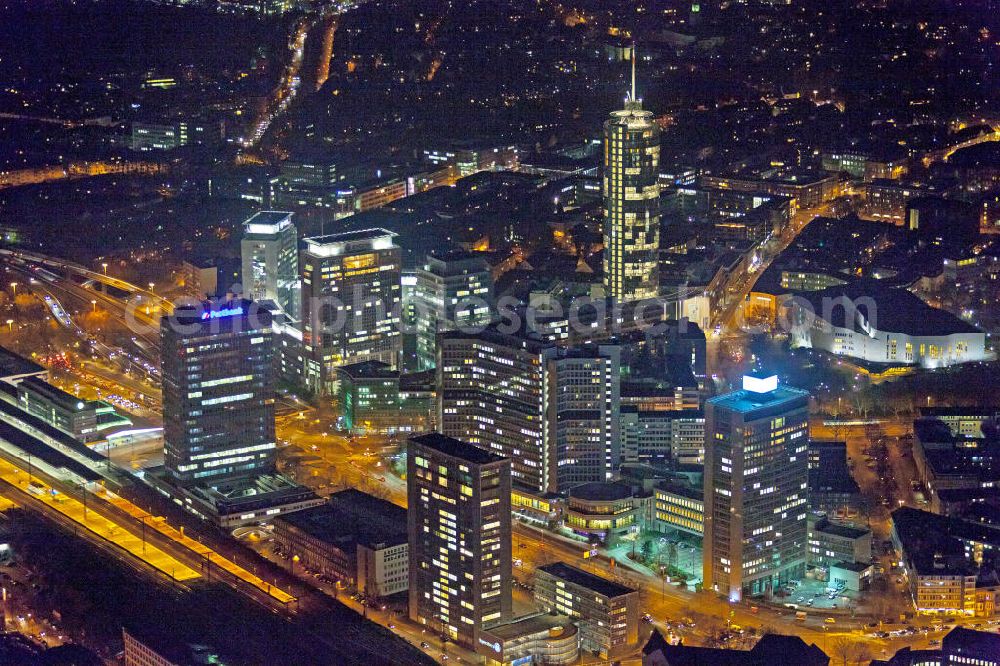 Aerial image at night Essen - Nachtluftbild auf die RWE-Konzernzentrale in Essen. Der RWE-Turm bildet mit 120 m Höhe und 500 Arbeitsplätzen die Zentrale des Energieversorgers RWE. Das Hochhaus ist ökologische orientiert konzipiert und gewinnt natürliche Energie aus Tageslicht und Sonnenwärme. View of the RWE headquarters in Essen at night. The RWE Tower is with 120 meters and up to 500 workplaces the headquarter of the energy supplier RWE. The tower is designed ecological and gains energy from natural daylight and solar heat.