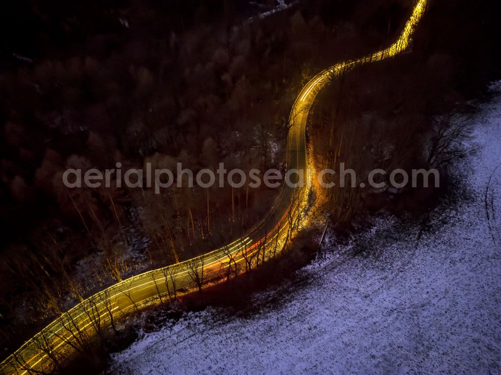 Aerial photograph at night Augustusburg - Night lighting serpentine-shaped curve of a road guide with front and rear lights of passing vehicles on street S 223 in Augustusburg in the state Saxony, Germany