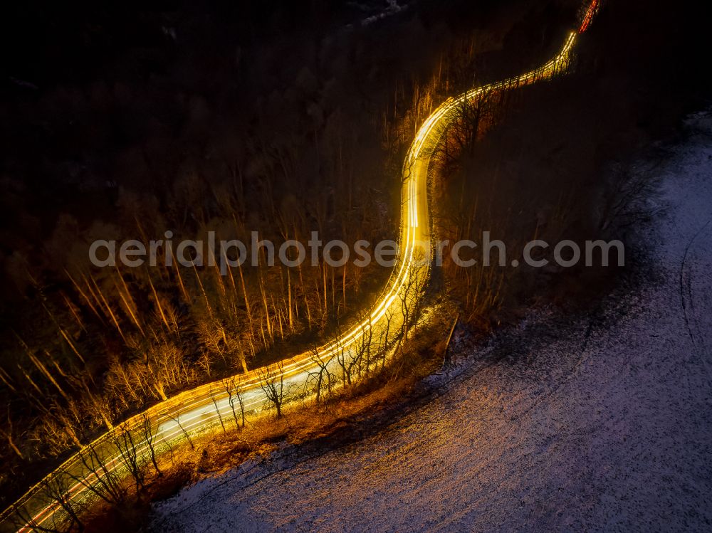 Aerial image at night Augustusburg - Night lighting serpentine-shaped curve of a road guide with front and rear lights of passing vehicles on street S 223 in Augustusburg in the state Saxony, Germany