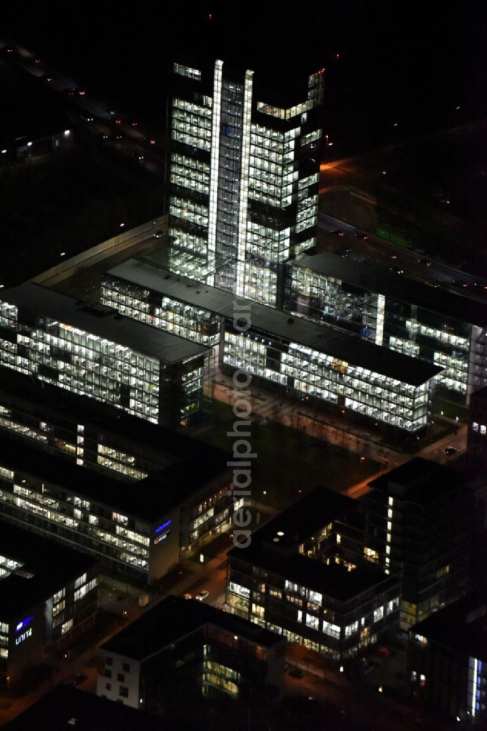 Aerial image at night München - Night lighting administration building of the company of OSRAM GmbH on Marcel-Breuer-Strasse in the district Schwabing-Freimann in Munich in the state Bavaria, Germany