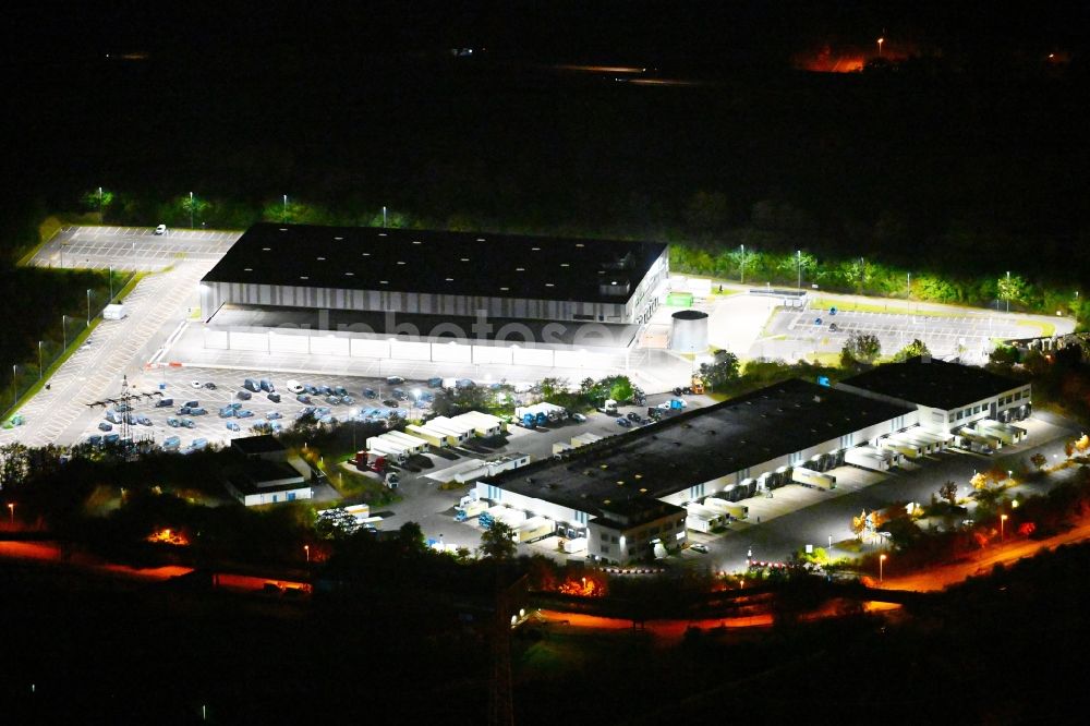 Aerial photograph at night Völklingen - Night lighting freight forwarding building a logistics and transport company of Kraftverkehr Nagel SE & Co. KG on street Kurt-Nagel-Strasse in the district Luisenthal in Voelklingen in the state Saarland, Germany