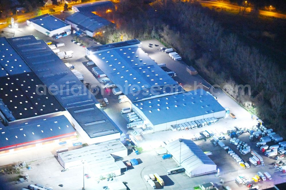 Potsdam at night from the bird perspective: Night lighting Freight forwarding building a logistics and transport company Krage Potsdam GmbH Am Buchhorst in Potsdam in the state Brandenburg