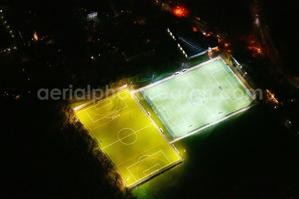 Berlin at night from the bird perspective: Night lighting Sports grounds and football pitch Hubertus-Sportplatz on Wangenheimstrasse in the district Wilmersdorf in Berlin, Germany