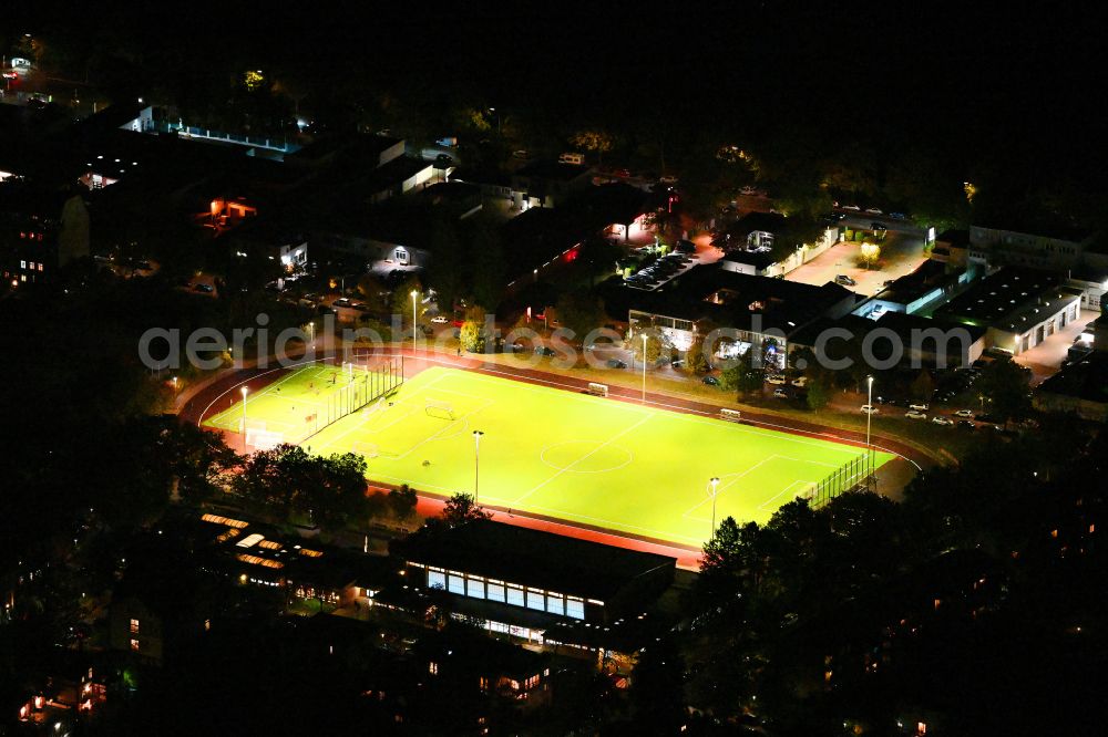 Aerial image at night Berlin - Night lighting sports grounds and football pitch Sochos Sportplatz on street Lessingstrasse in the district Steglitz in Berlin, Germany