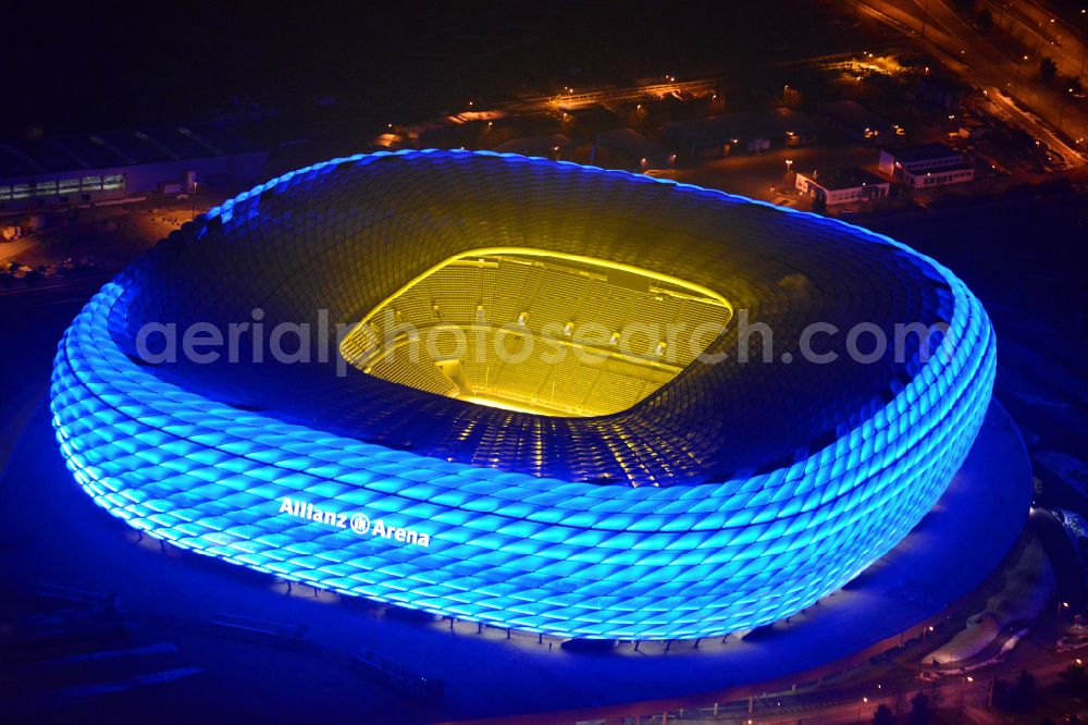 München at night from above - Night lighting sports facility grounds of the Arena stadium Allianz Arena on Werner-Heisenberg-Allee in Munich in the state Bavaria, Germany