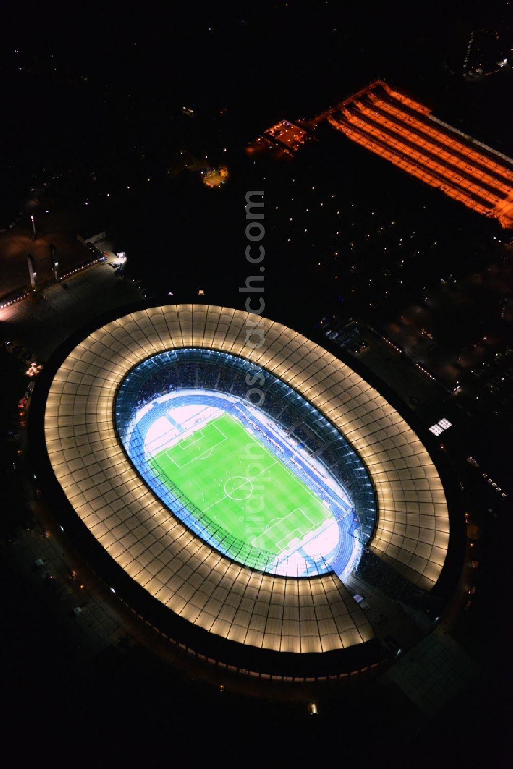 Aerial photograph at night Berlin - Night lighting Sports facility grounds of the Arena stadium Olympiastadion of Hertha BSC in Berlin in Germany