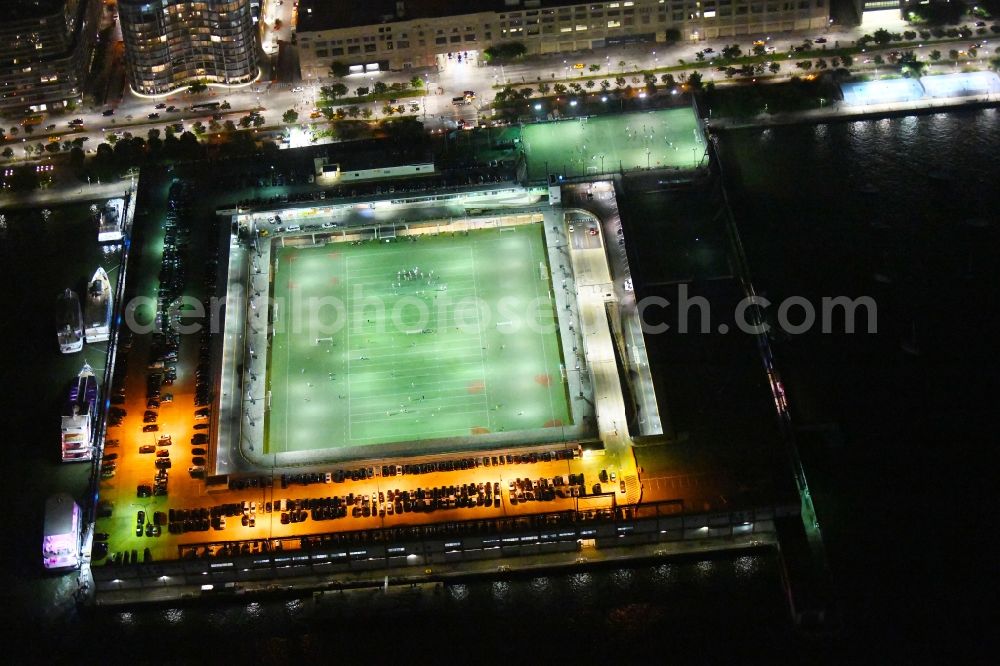 New York at night from the bird perspective: Night lighting Sports facility grounds of the Arena stadium Pier 40 at Soccer Field on Hudson River Park in the district Manhattan in New York in United States of America