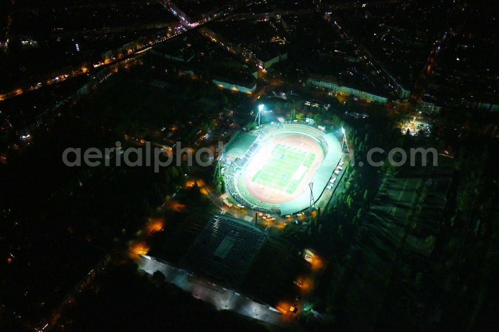 Berlin at night from the bird perspective: Night lighting Stadium at the Friedrich-Ludwig-Jahn-Sportpark in Berlin Prenzlauer Berg