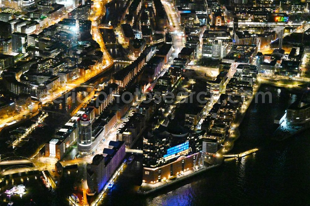 Aerial photograph at night Hamburg - Night lights and illumination City view of the inner city area with Elbphilharmonie and Speicherstadt on the banks of the Elbe river in Hamburg, Germany