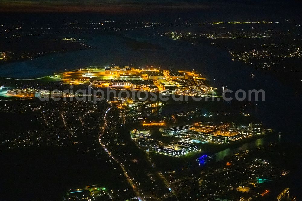 Hamburg at night from above - Night lighting city view on the river bank of the River Elbe in the district Finkenwerder in Hamburg, Germany