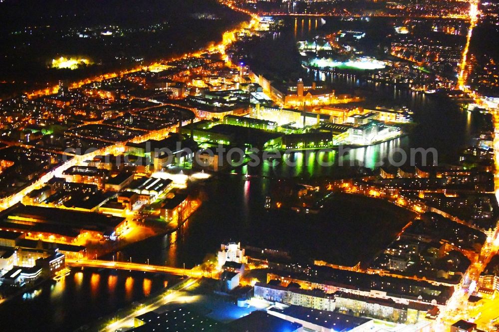 Aerial photograph at night Berlin - Night lighting of the city view on the river bank of Spree River in the district Oberschoeneweide in Berlin, Germany