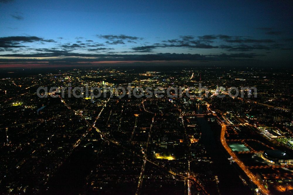 Aerial image at night Berlin - City district night Aerial view Friedrichshain -Kreuzberg at the riverside at the Anschutz-Areal with the O2 Arena in the urban area in Berlin