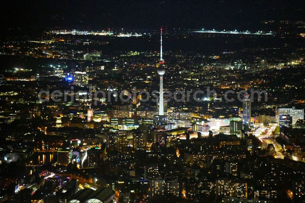 Berlin at night from the bird perspective: Night lighting the city center in the downtown area at the Berlin TV tower in the district Mitte in Berlin, Germany