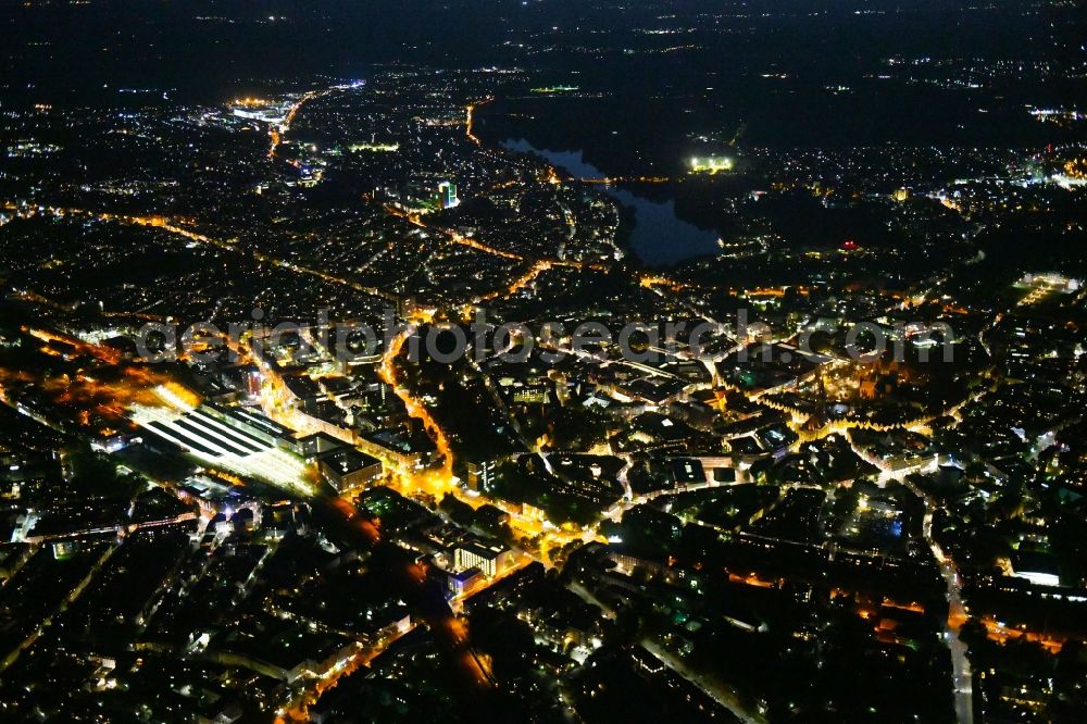 Aerial photograph at night Münster - Night lighting The city center in the downtown area on Central Station in Muenster in the state North Rhine-Westphalia, Germany