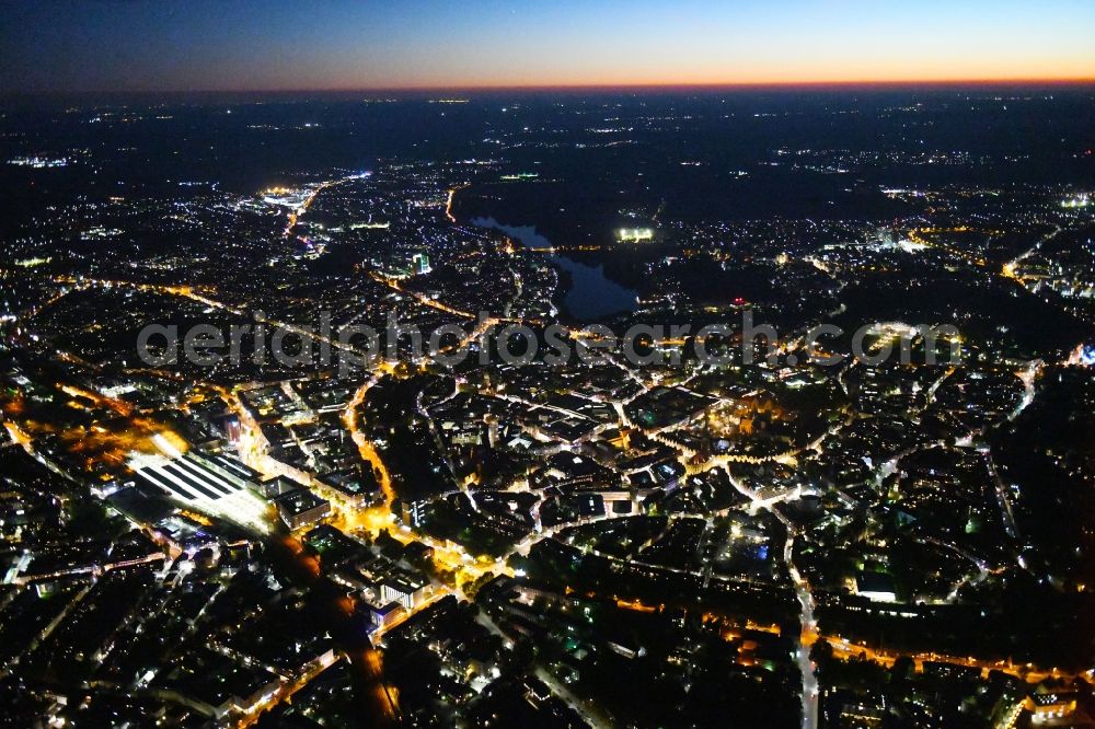 Aerial image at night Münster - Night lighting The city center in the downtown area on Central Station in Muenster in the state North Rhine-Westphalia, Germany