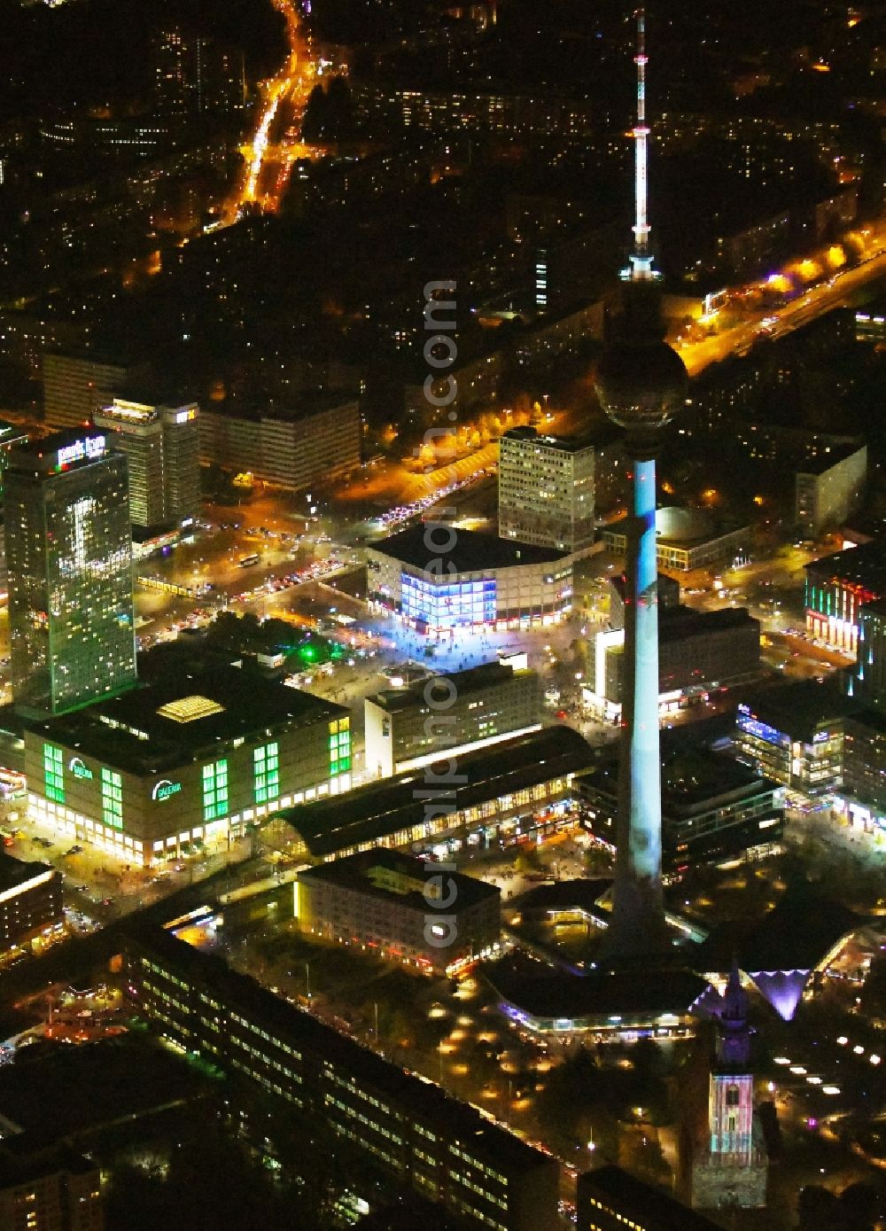 Aerial image at night Berlin - Night lighting The city center in the downtown area Ost on Berliner Fernsehturm - Alexanderstrasse - Rathausstrasse in the district Mitte in Berlin, Germany