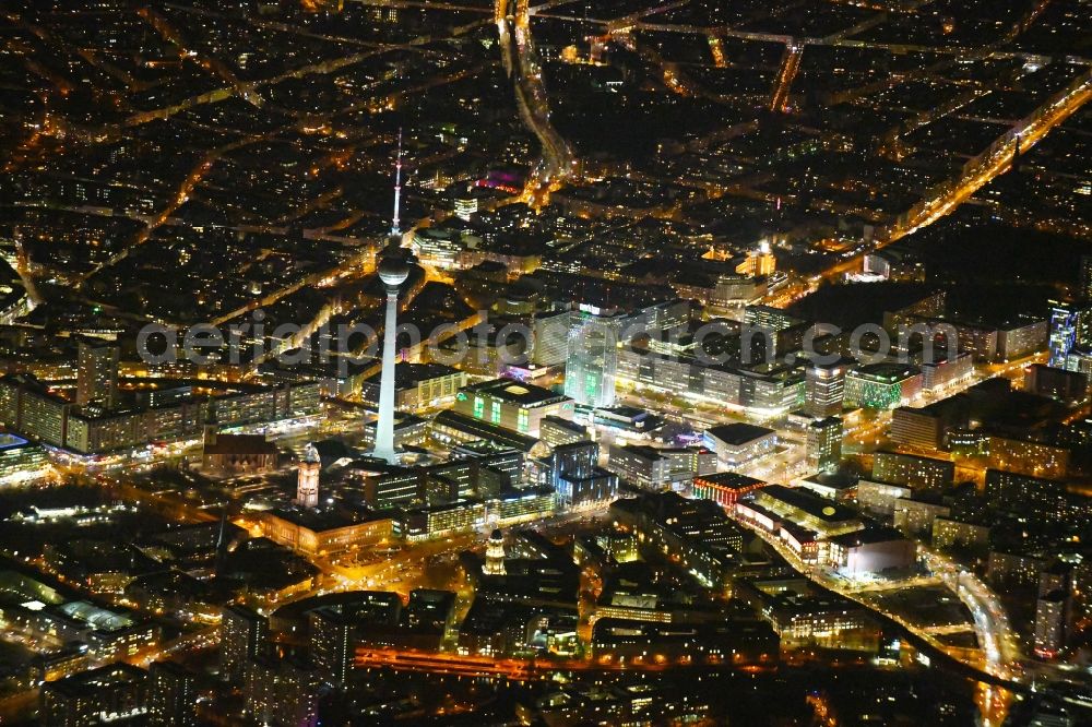 Aerial image at night Berlin - Night lighting The city center in the downtown area Ost on Berliner Fernsehturm - Alexanderstrasse - Rathausstrasse - Unter den Linden in the district Mitte in Berlin, Germany