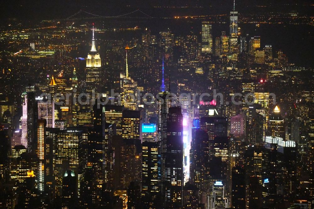 New York at night from the bird perspective: Night lighting City center with the skyline in the downtown area on Broadway in the district Manhattan in New York in United States of America