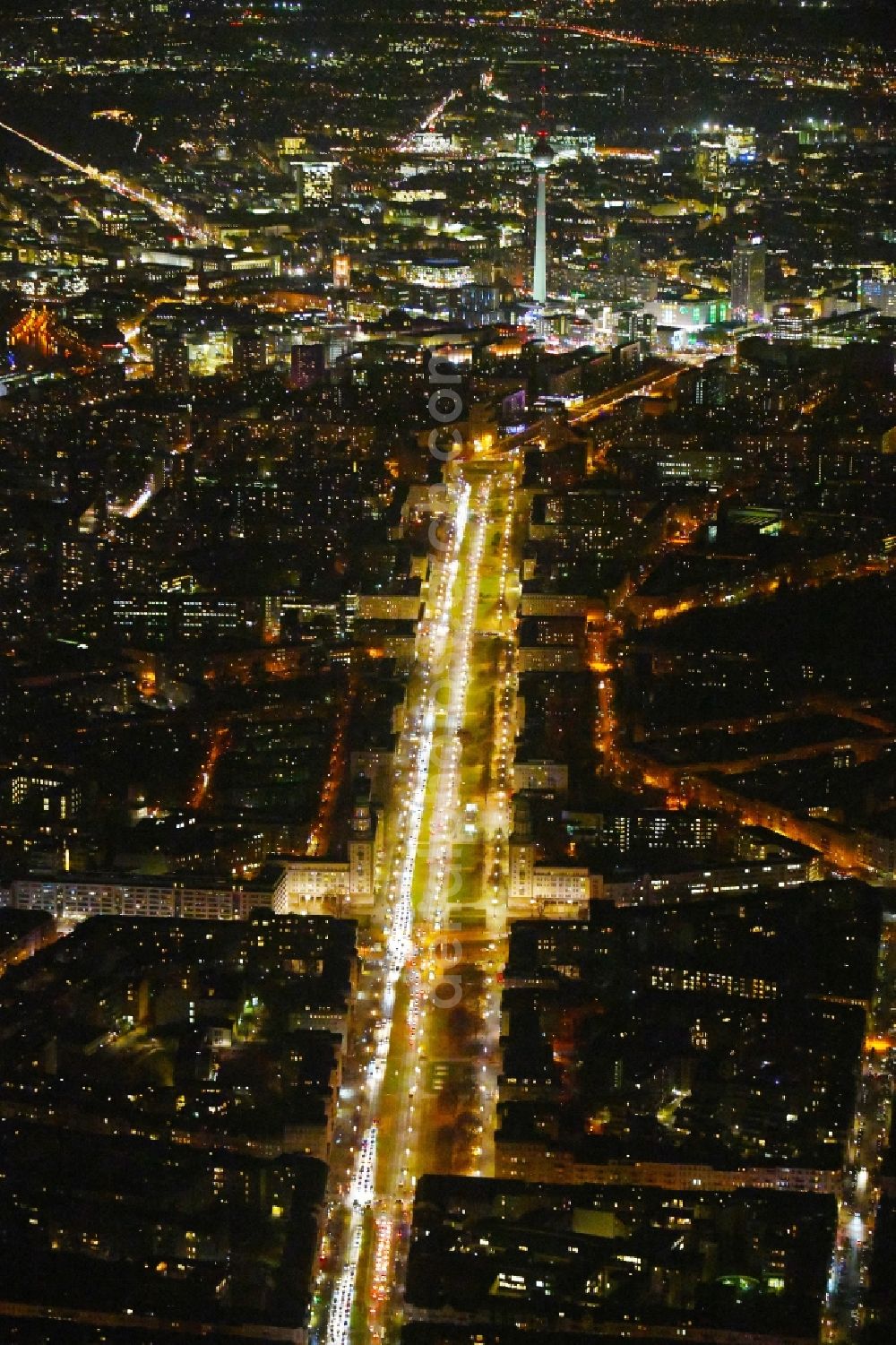 Berlin at night from the bird perspective: Night lighting Street guide of famous promenade and shopping street Karl-Marx-Allee Frankfurter Tor - Frankfurter Allee in the district Friedrichshain in Berlin, Germany