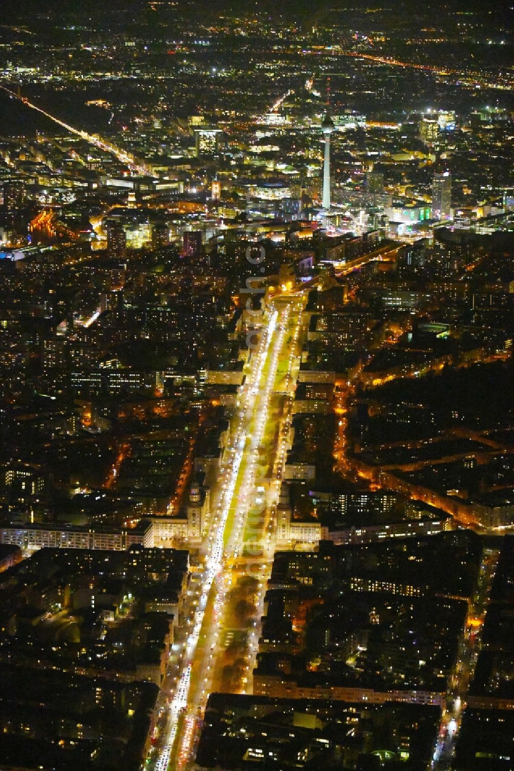 Aerial image at night Berlin - Night lighting Street guide of famous promenade and shopping street Karl-Marx-Allee Frankfurter Tor - Frankfurter Allee in the district Friedrichshain in Berlin, Germany