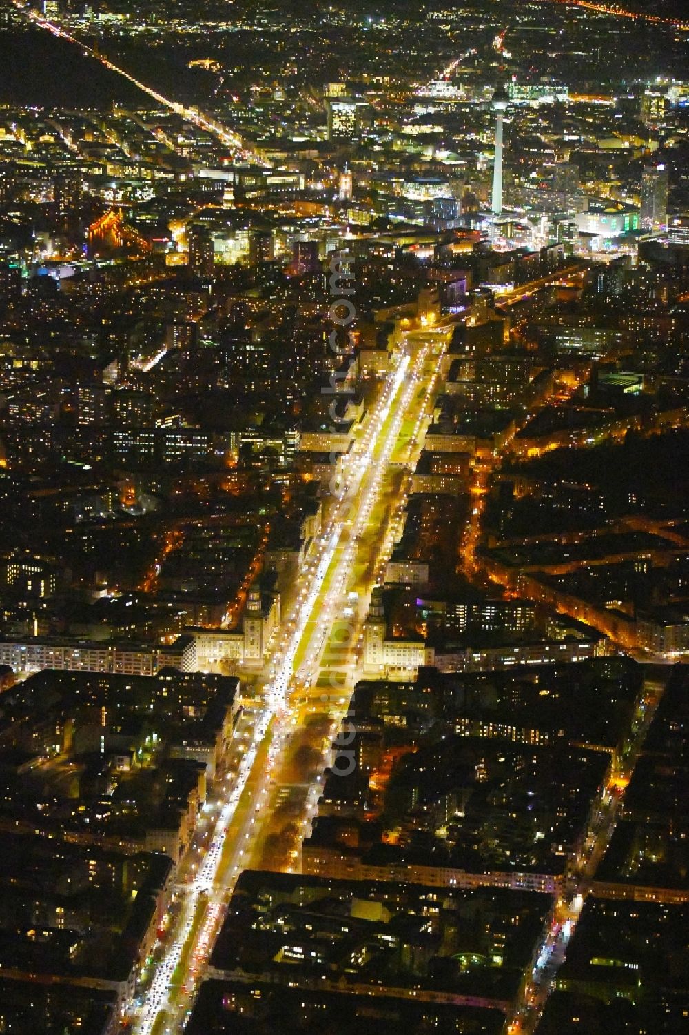 Berlin at night from above - Night lighting Street guide of famous promenade and shopping street Karl-Marx-Allee Frankfurter Tor - Frankfurter Allee in the district Friedrichshain in Berlin, Germany