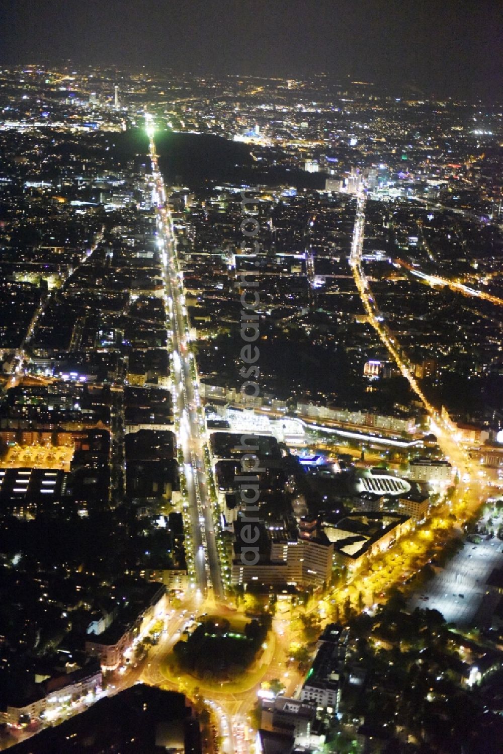 Berlin at night from the bird perspective: Night view street guide of famous promenade and shopping street Theodor-Heuss-Platz - Kaiserdamm-Masurenallee in Berlin